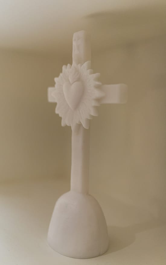 a white vase with a white flower