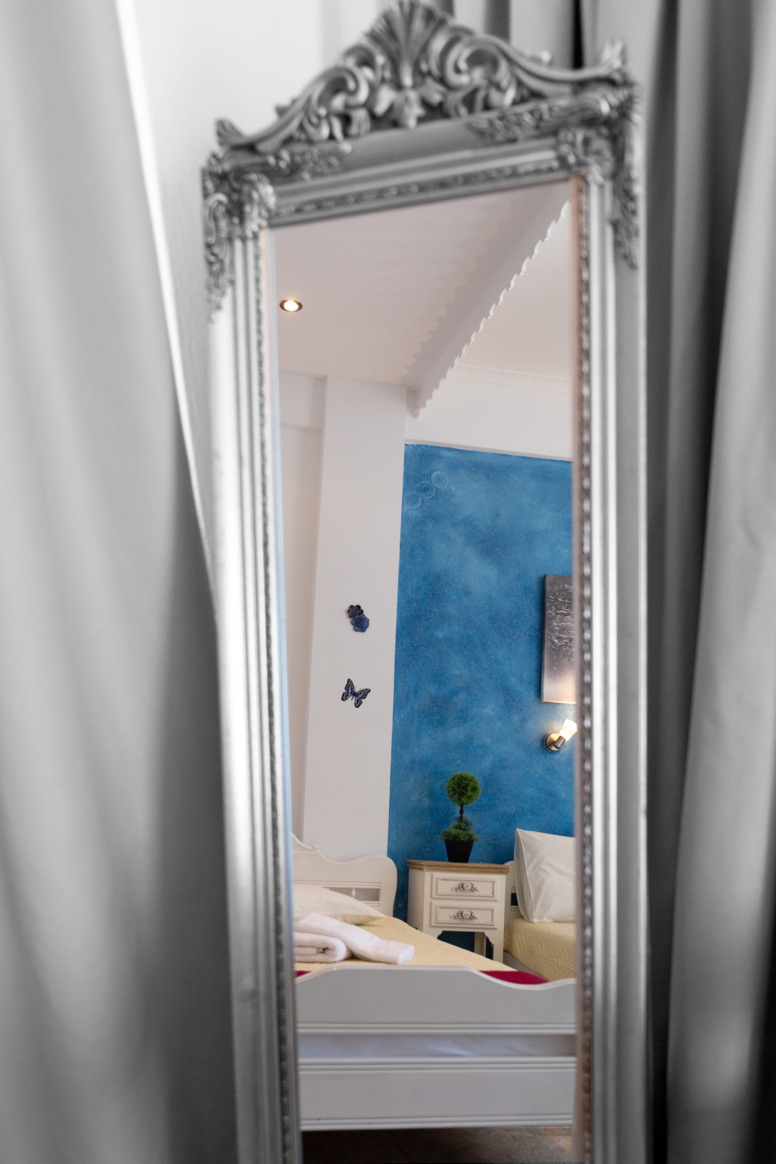 a mirror showing a bedroom