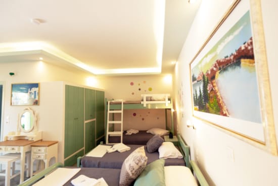 a bedroom with a bed and a painting on the wall