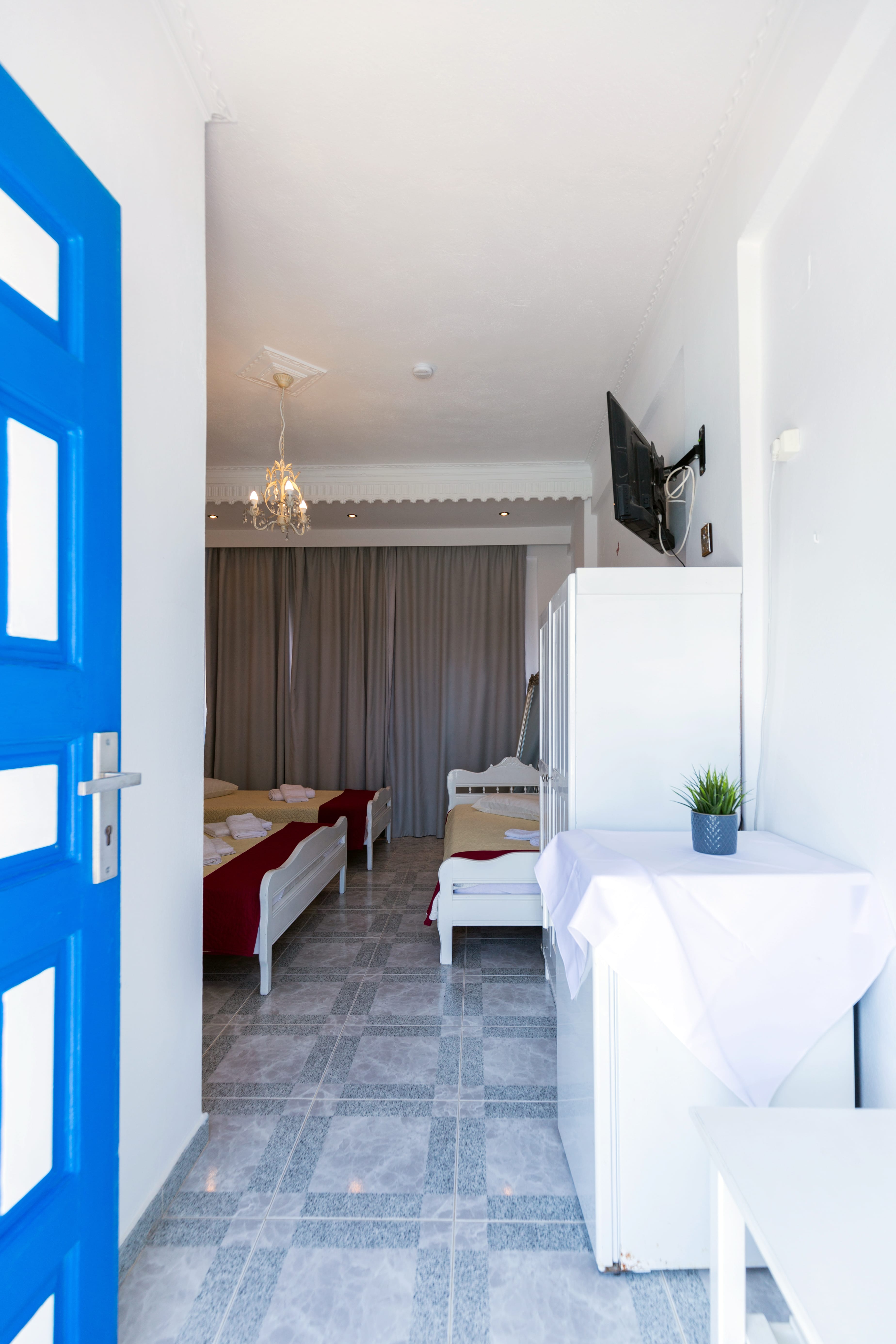 a room with a bed and a television