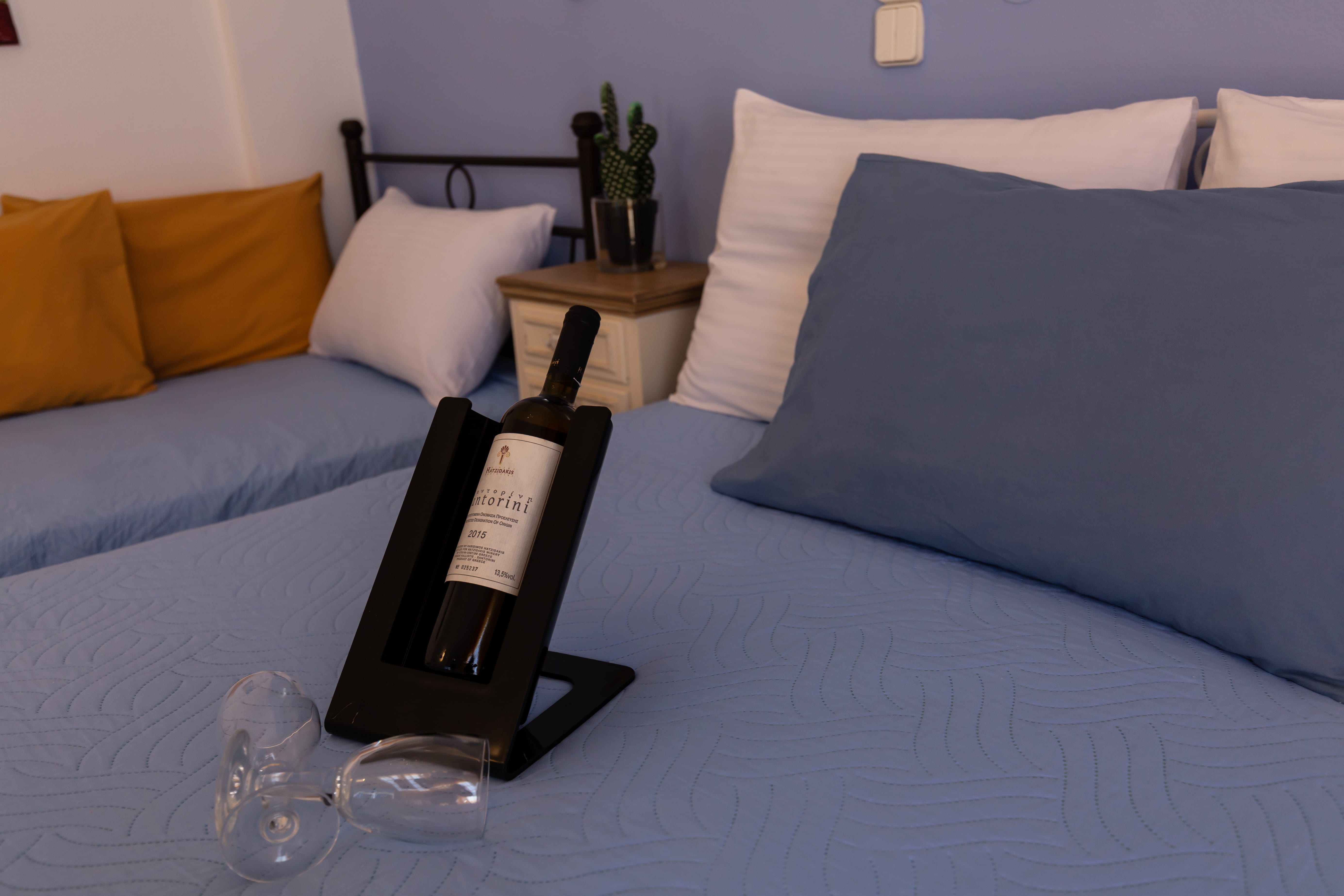 a bottle of wine on a bed