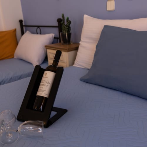 a bottle of wine on a bed