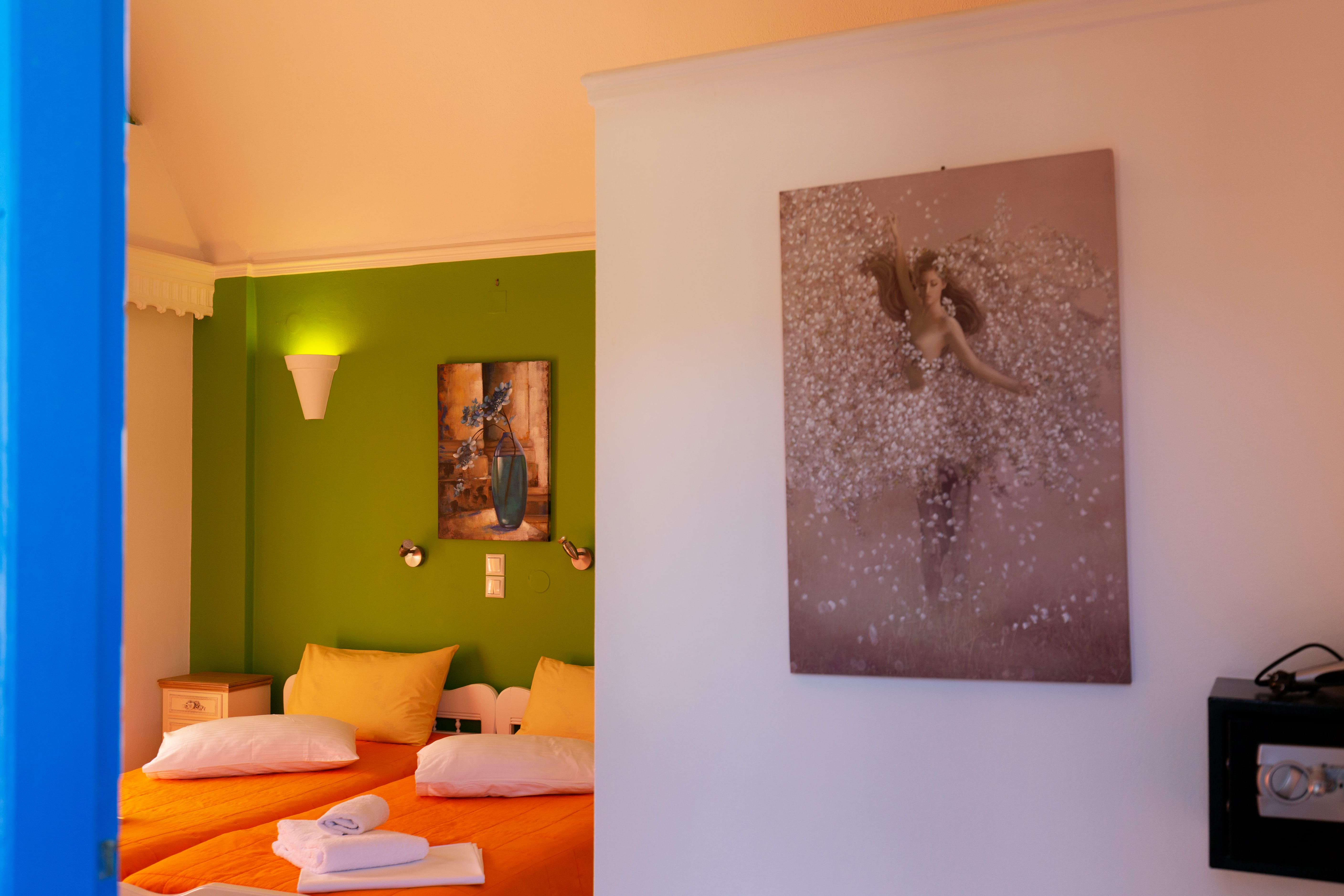 a room with a bed and a painting on the wall