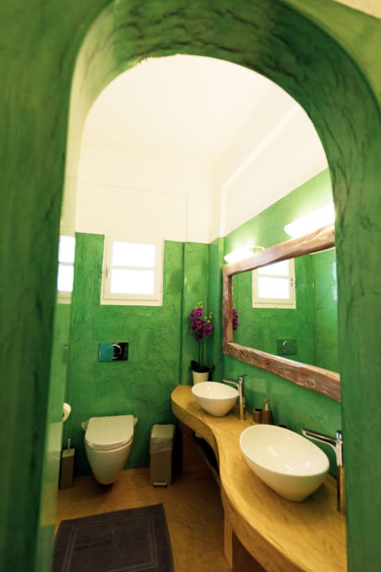 a bathroom with green walls