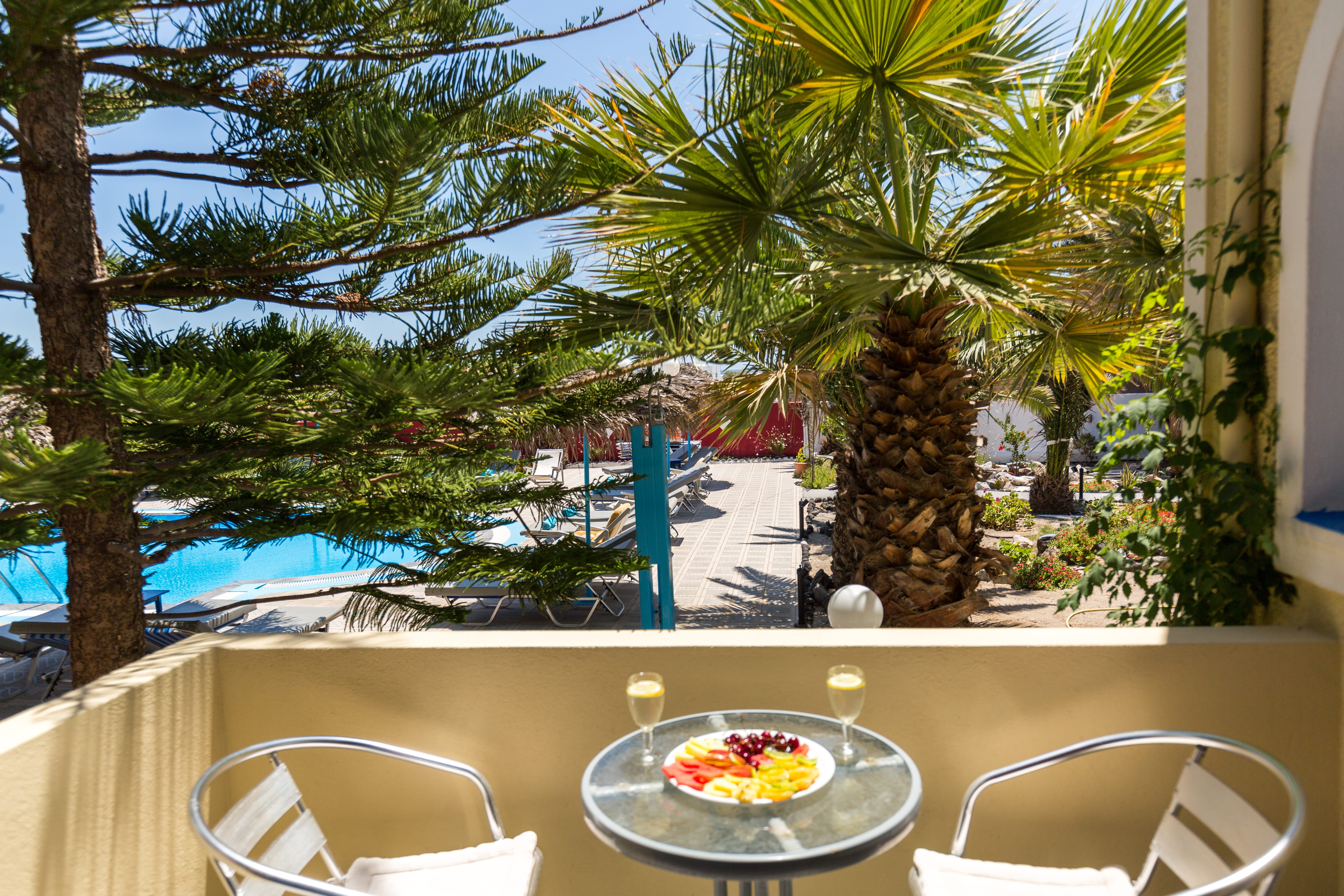 a table with a plate of food on it by a beach