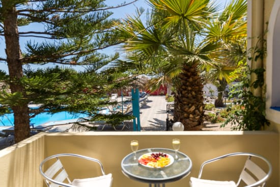 a table with a plate of food on it by a beach