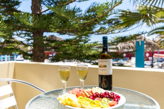 a bottle of wine and glasses of wine on a table