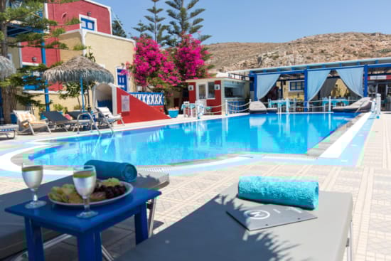 a pool with a table and chairs