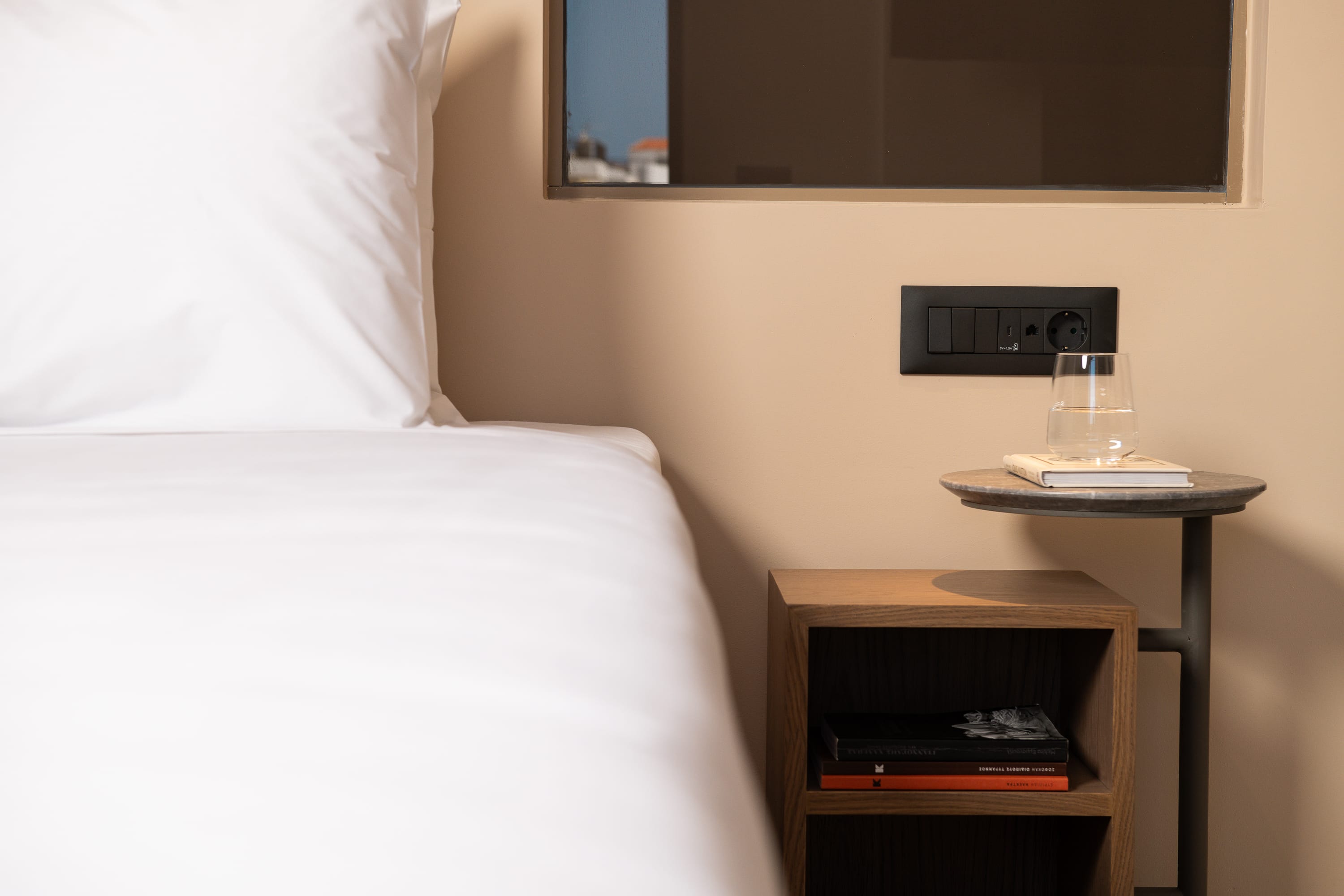 a bed with a mirror on the wall