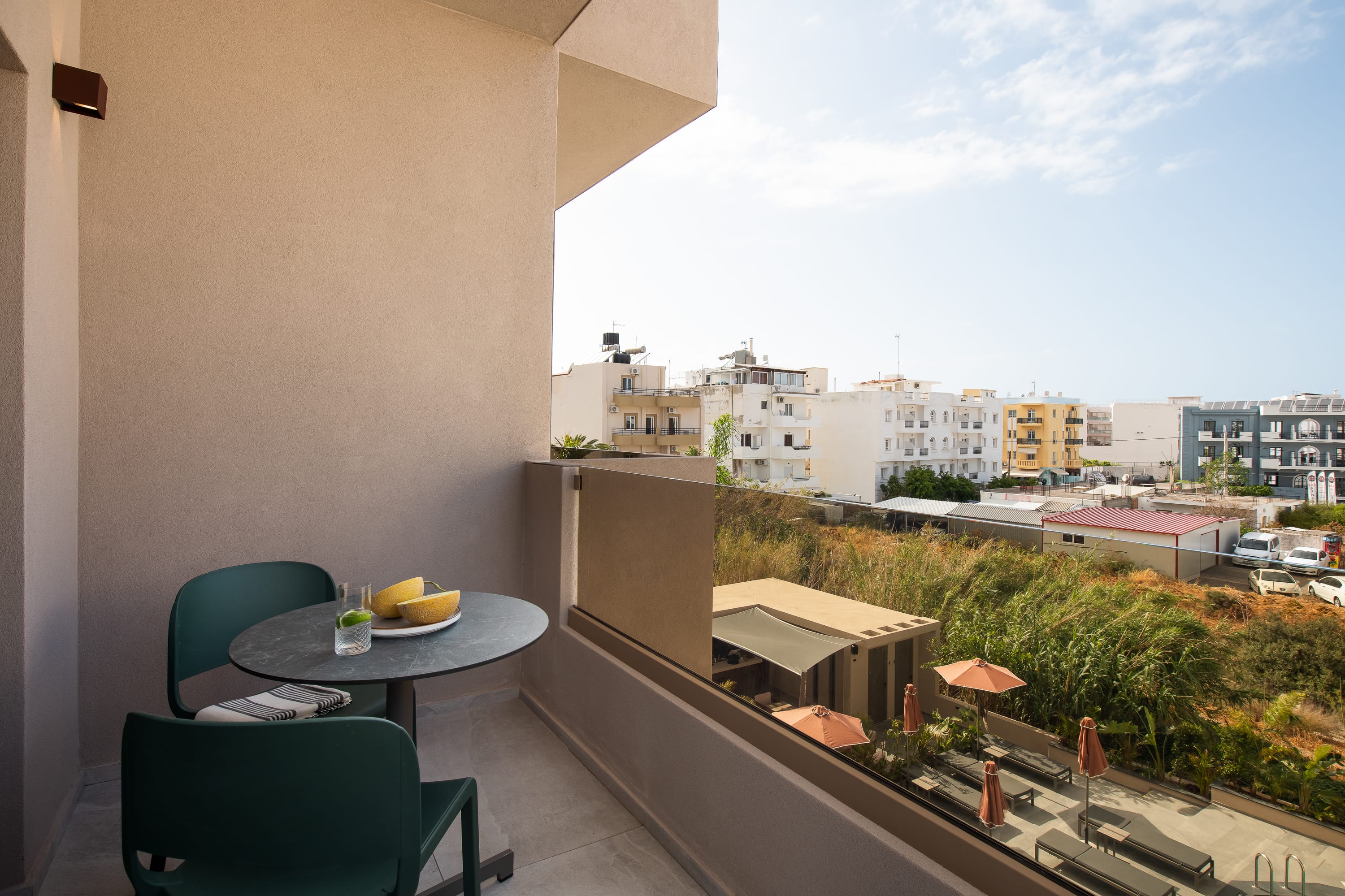 a balcony with a table and chairs