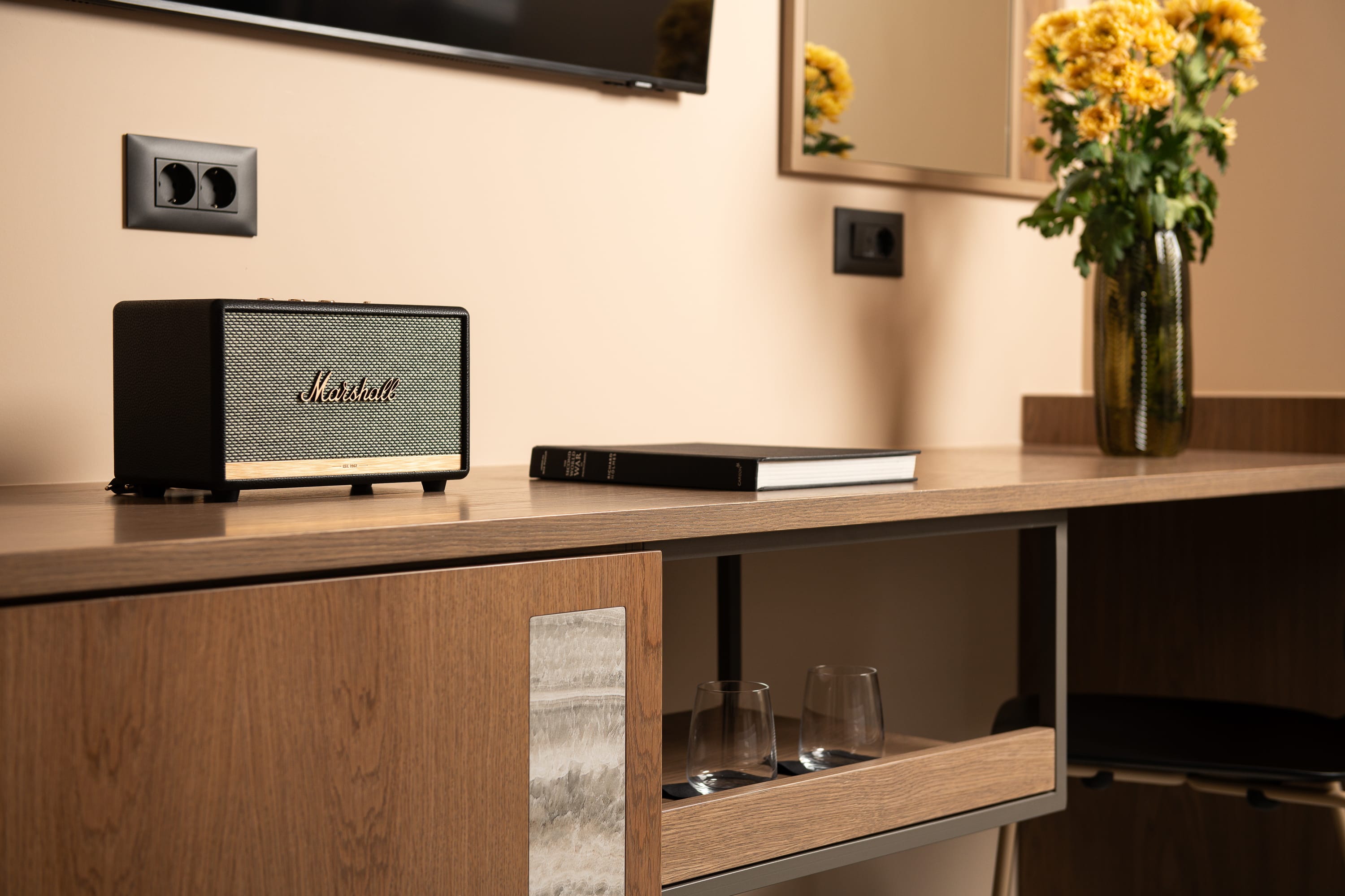 a desk with a computer and glasses