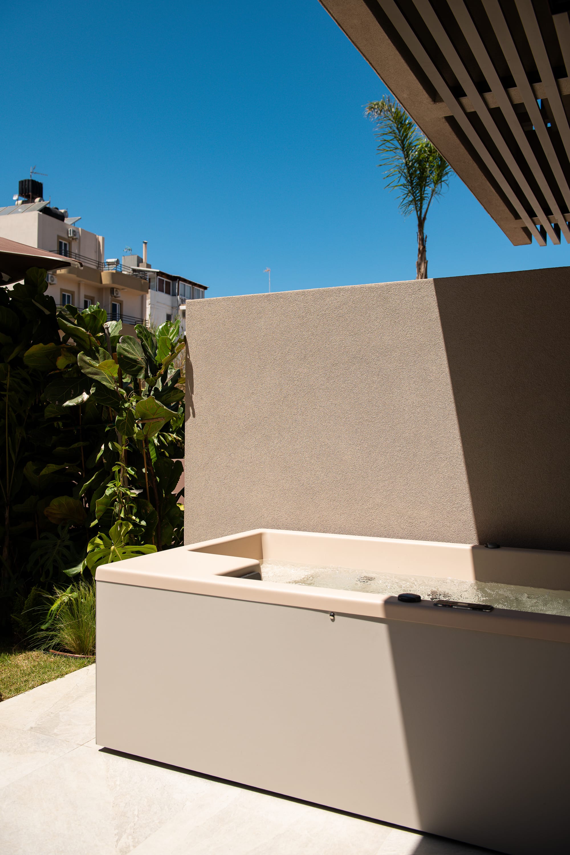 a white wall with a tree in the background