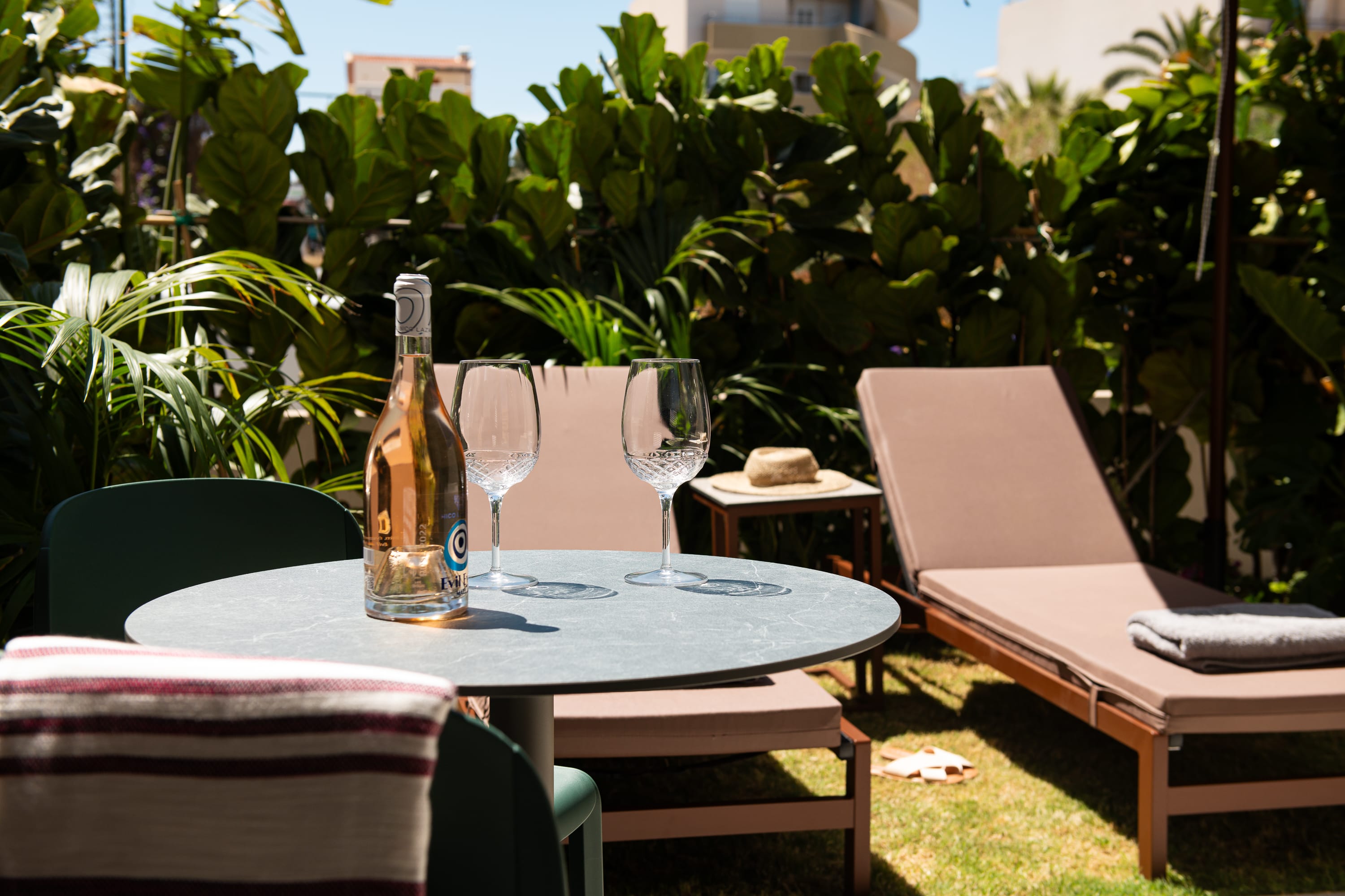 a table with wine glasses and a laptop on it