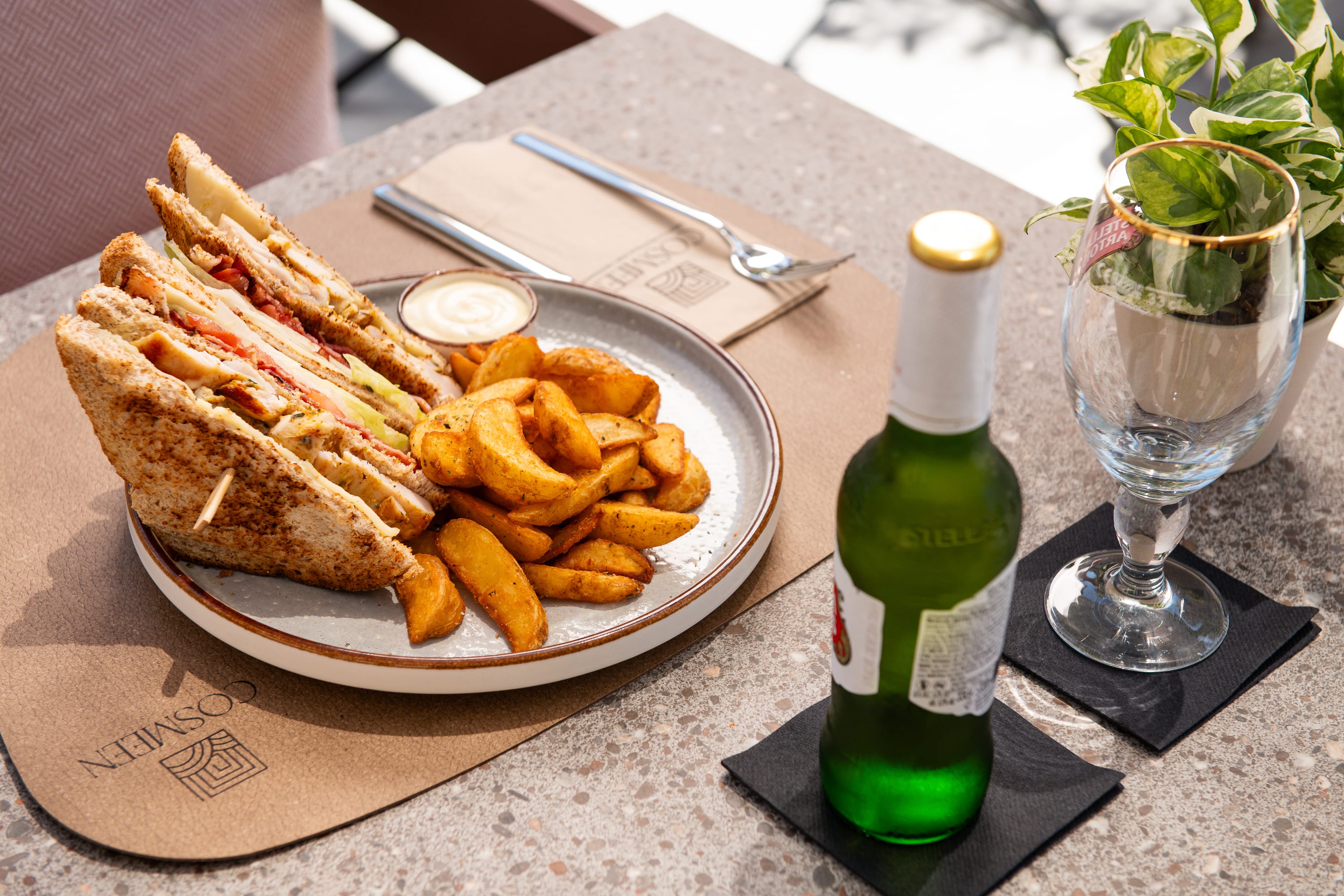 a plate of food and a bottle of wine on a table