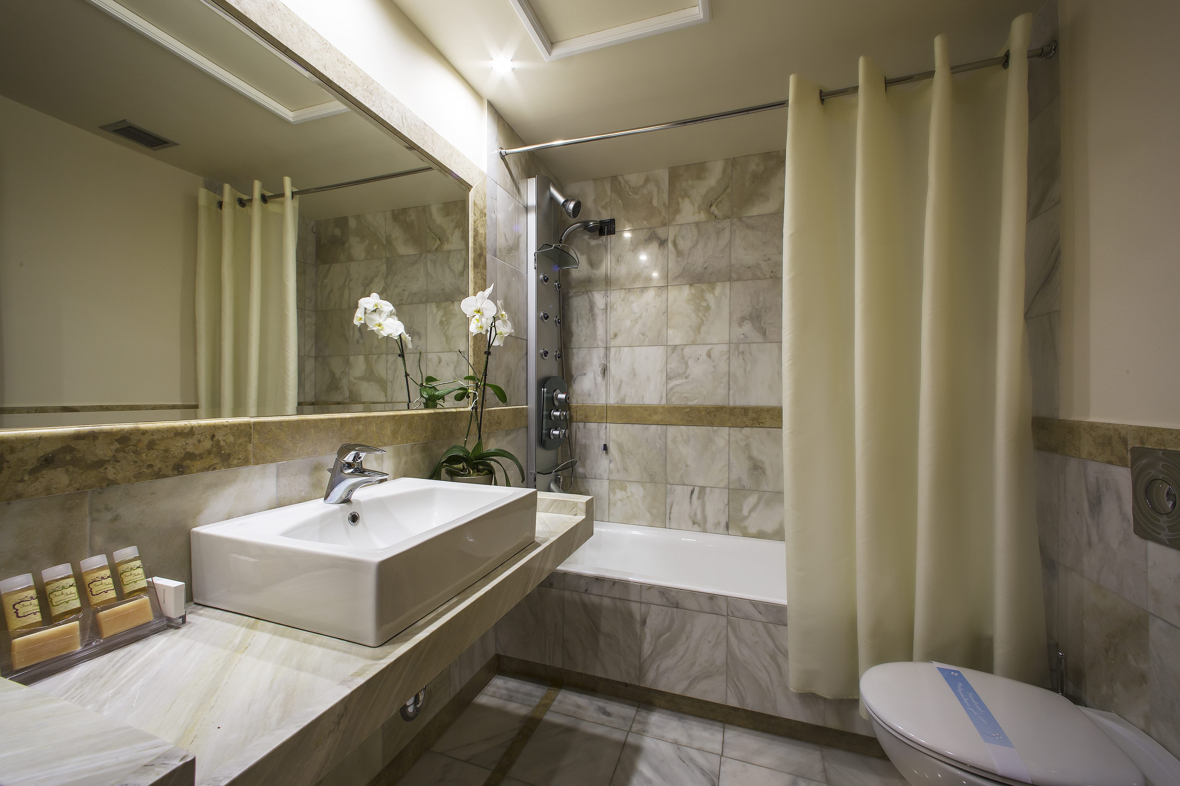a bathroom with a tub sink and toilet