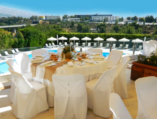 a set table with white chairs and white tables