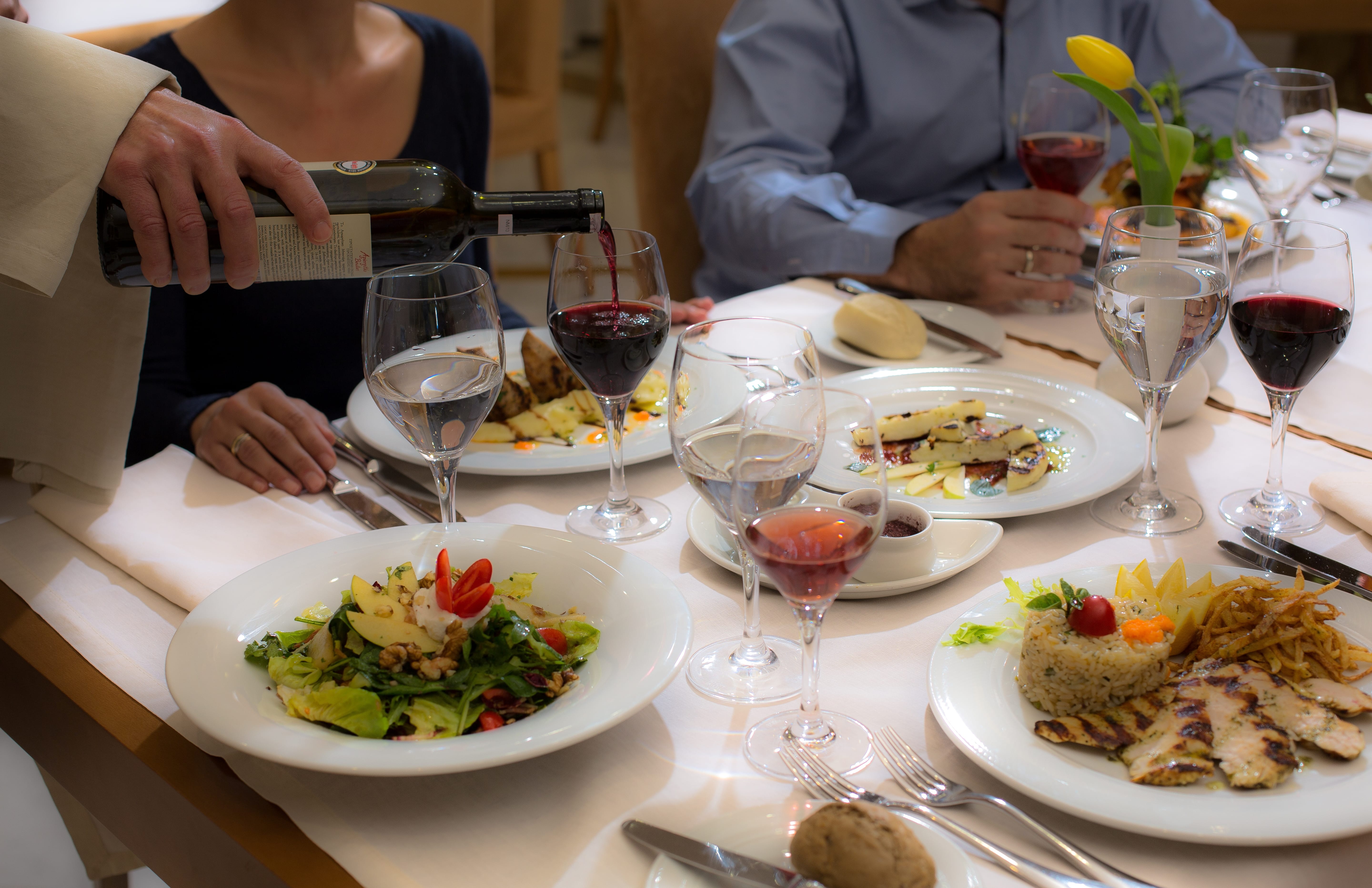 people sitting at a table with food