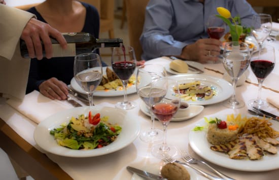 people sitting at a table with food