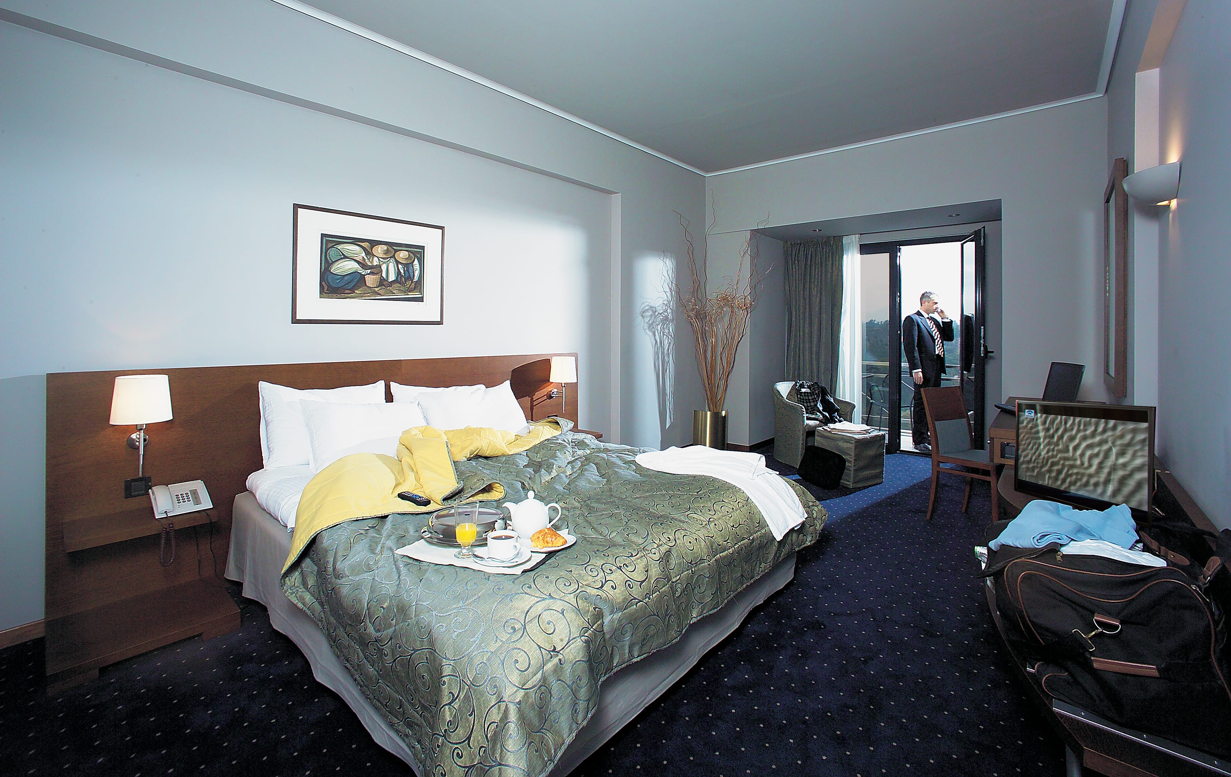 a hotel room with a bed and a table