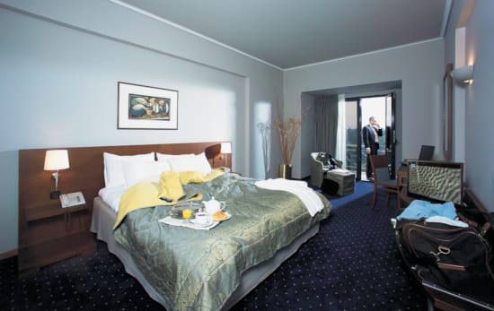 a hotel room with a bed and a table