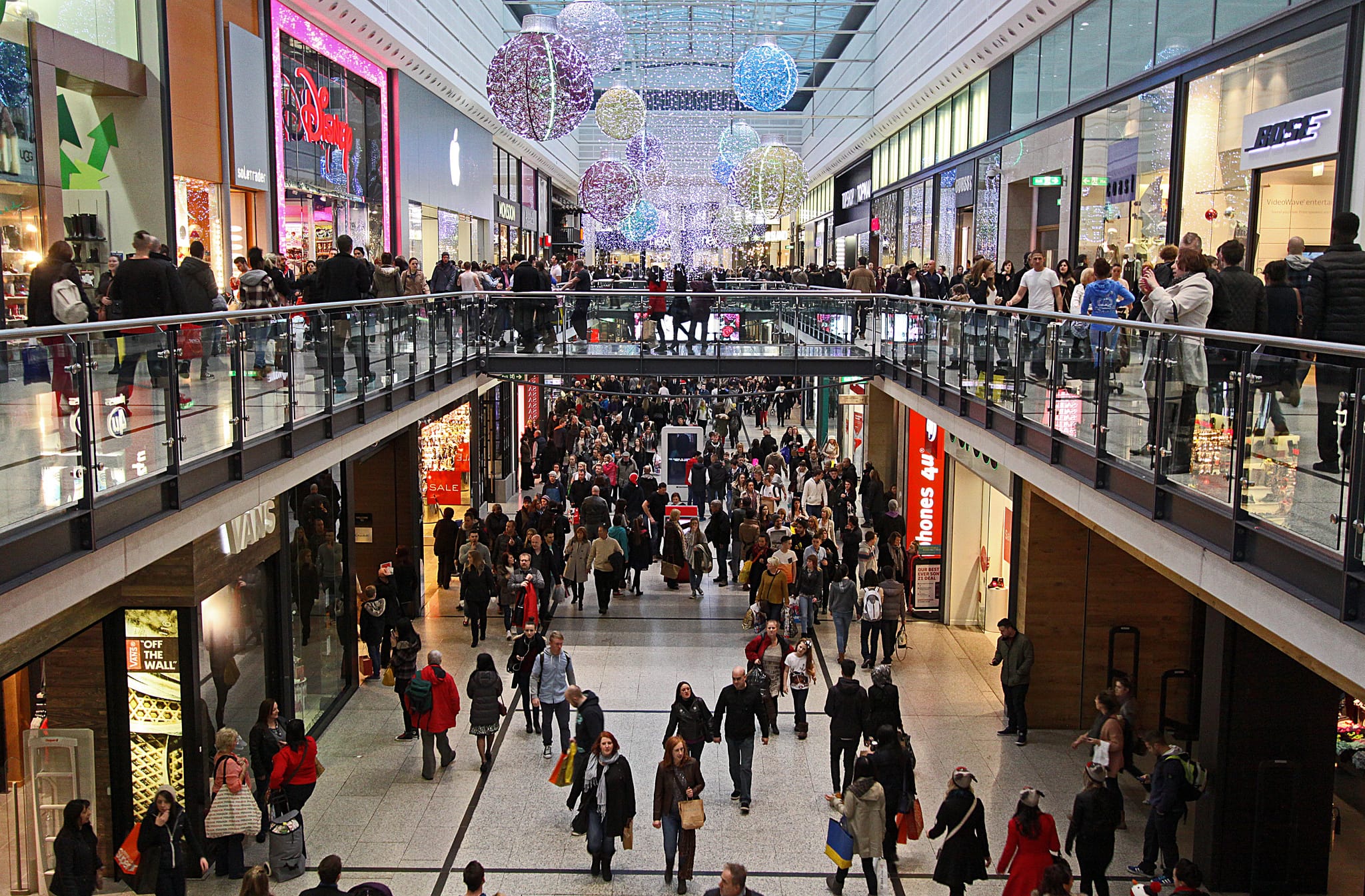 a group of people walking in a mall