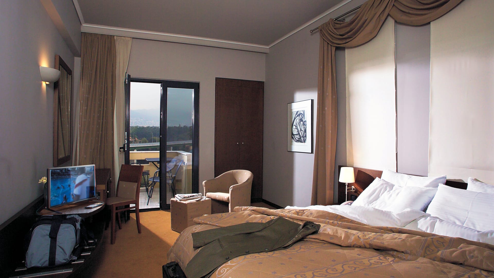 a hotel room with a bed and desk