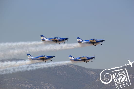a group of blue airplanes flying in the sky