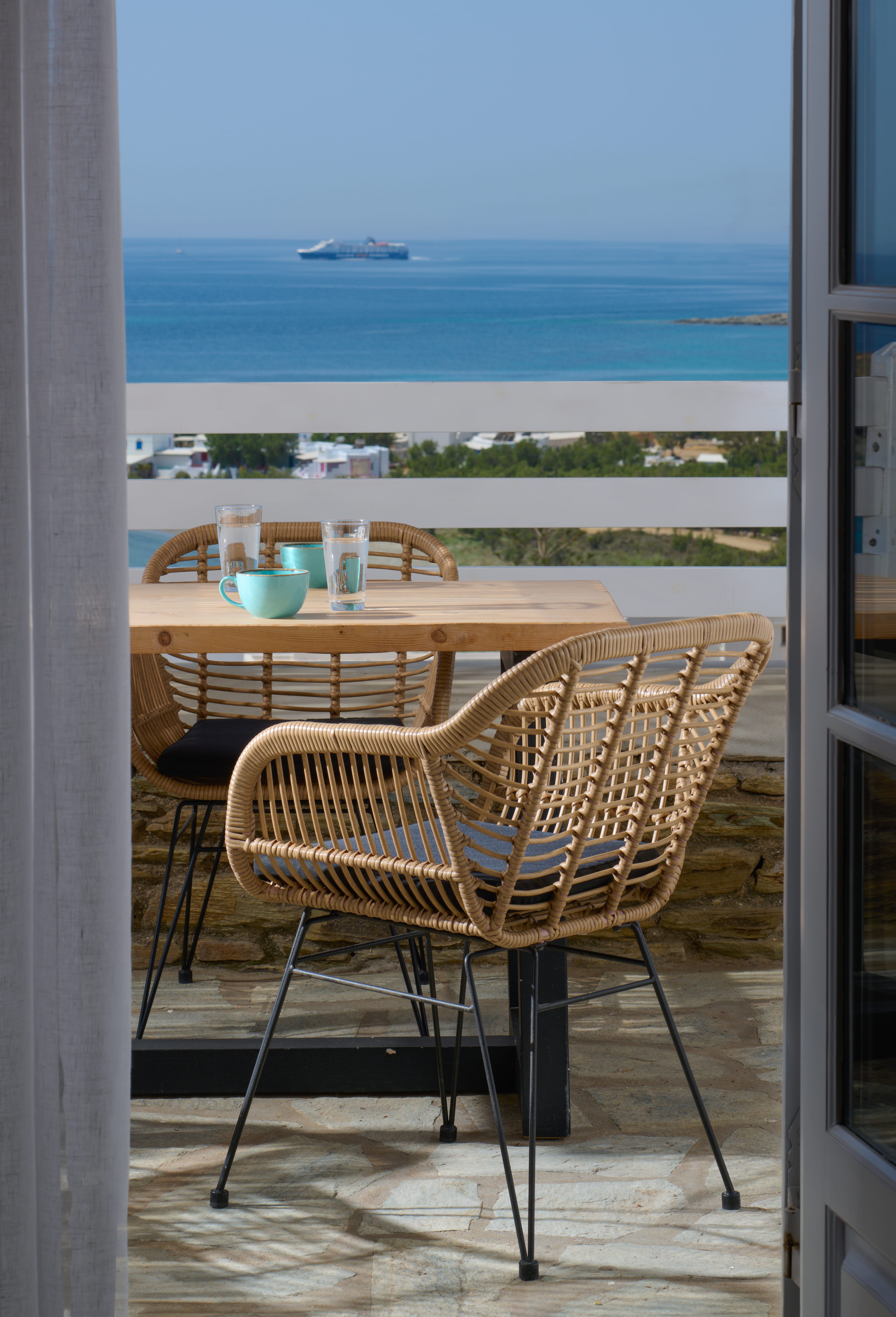 a table and chairs on a balcony