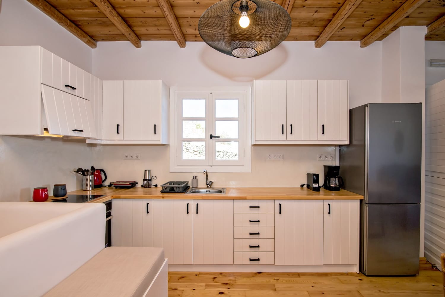 a kitchen with white cabinets