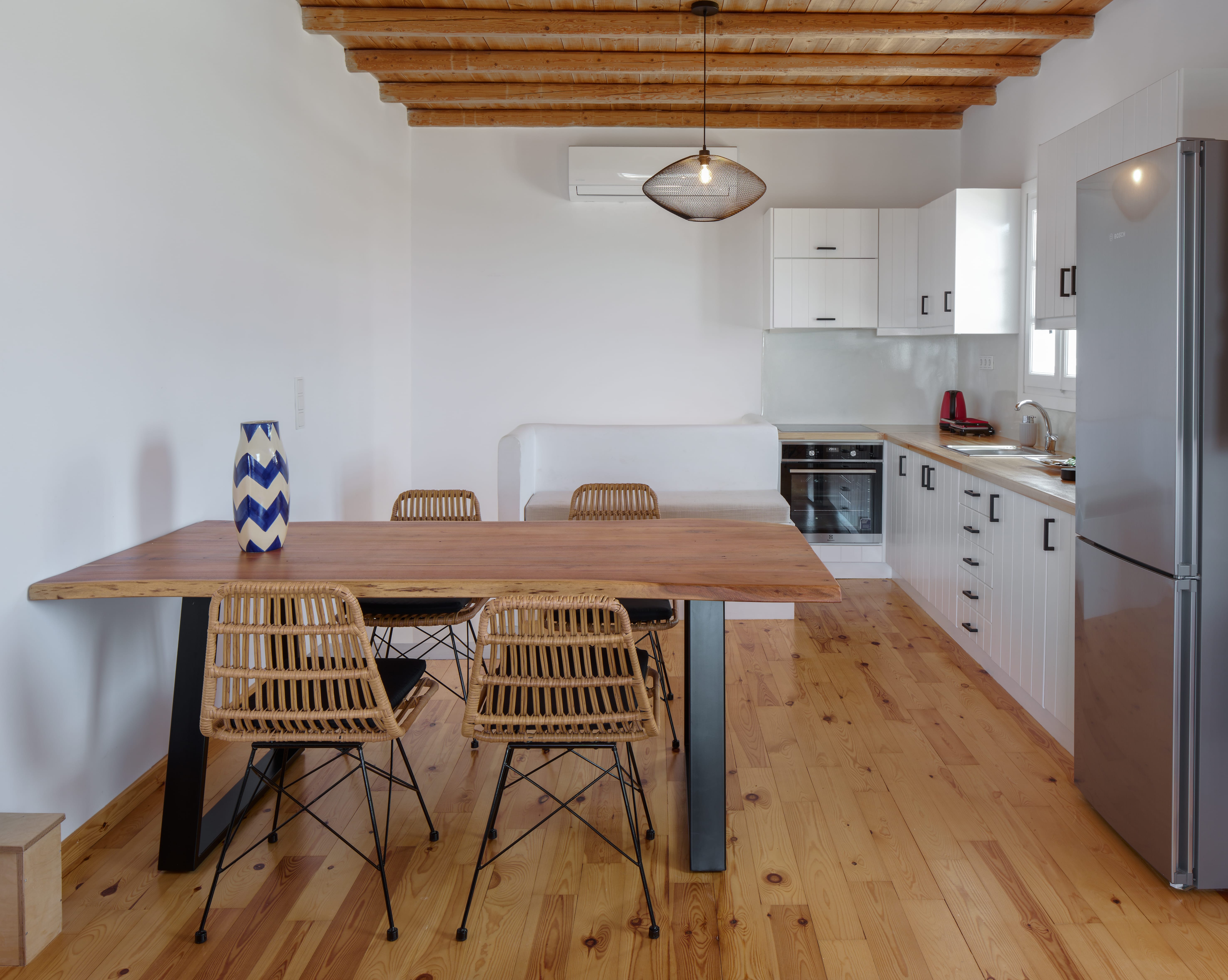 a kitchen with a table and chairs