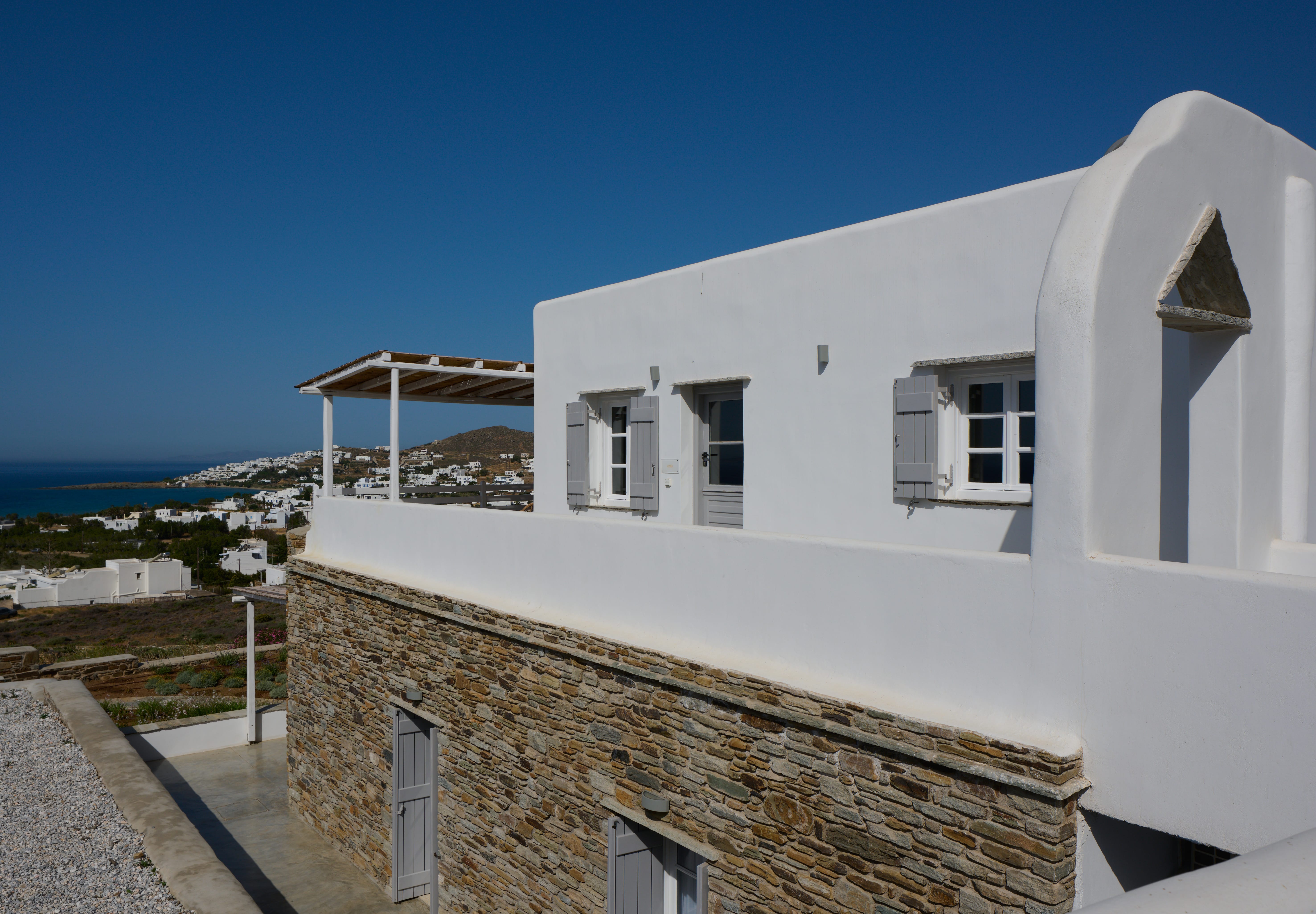 a white building with a stone wall