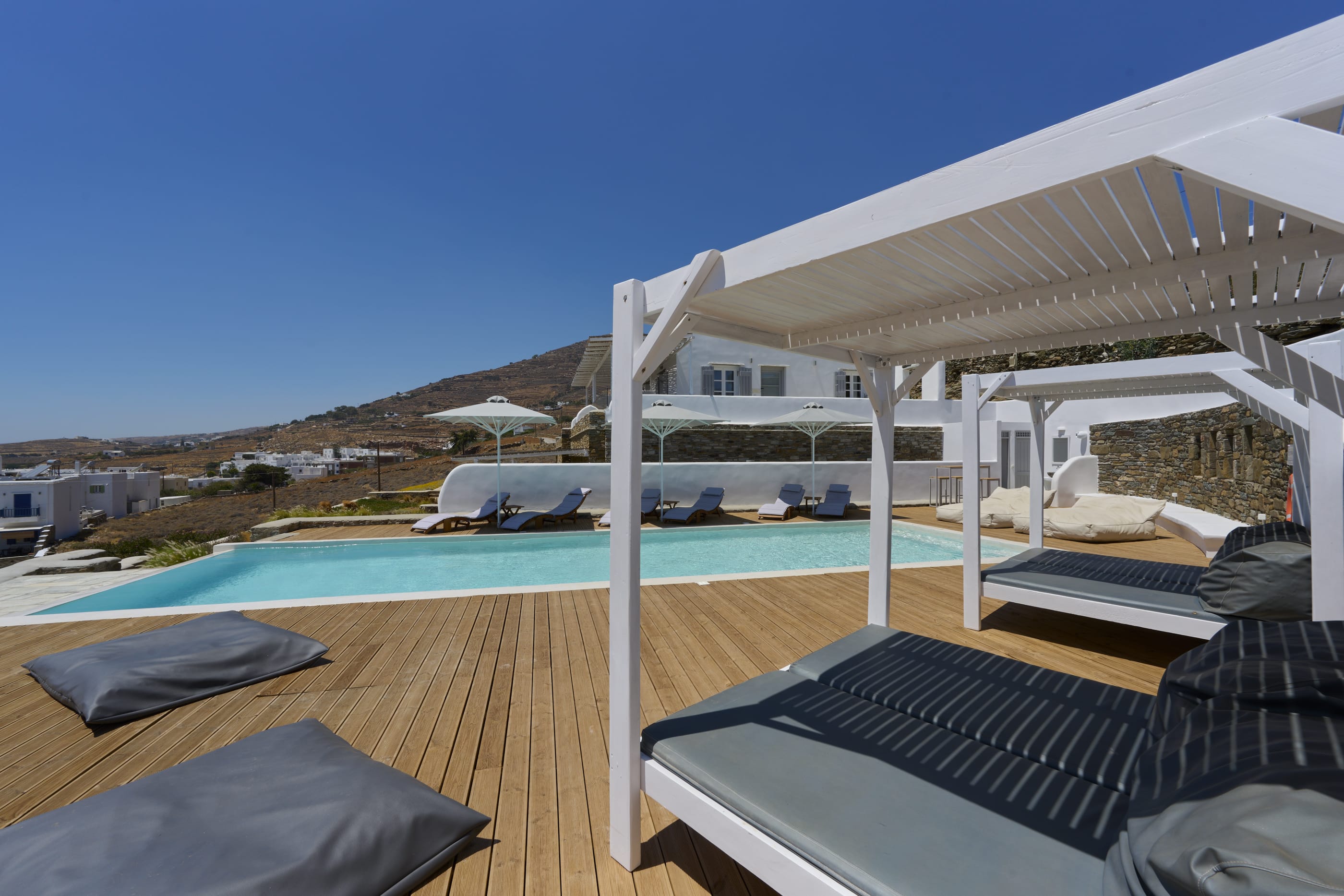 a deck with a pool and a view of a city