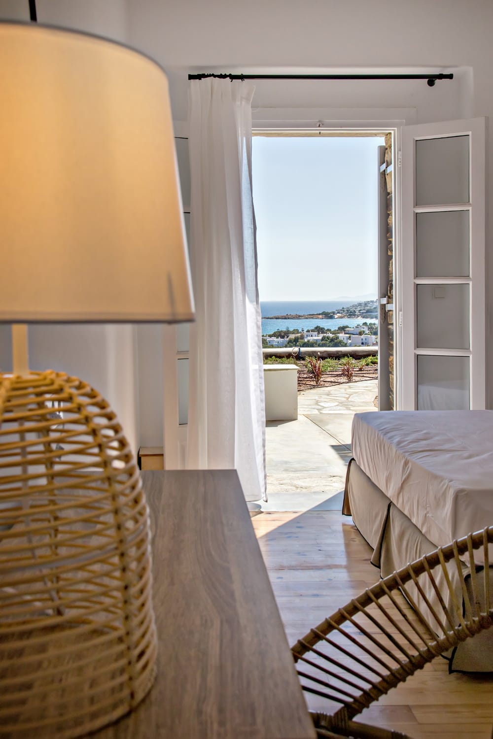 a bedroom with a view of the ocean