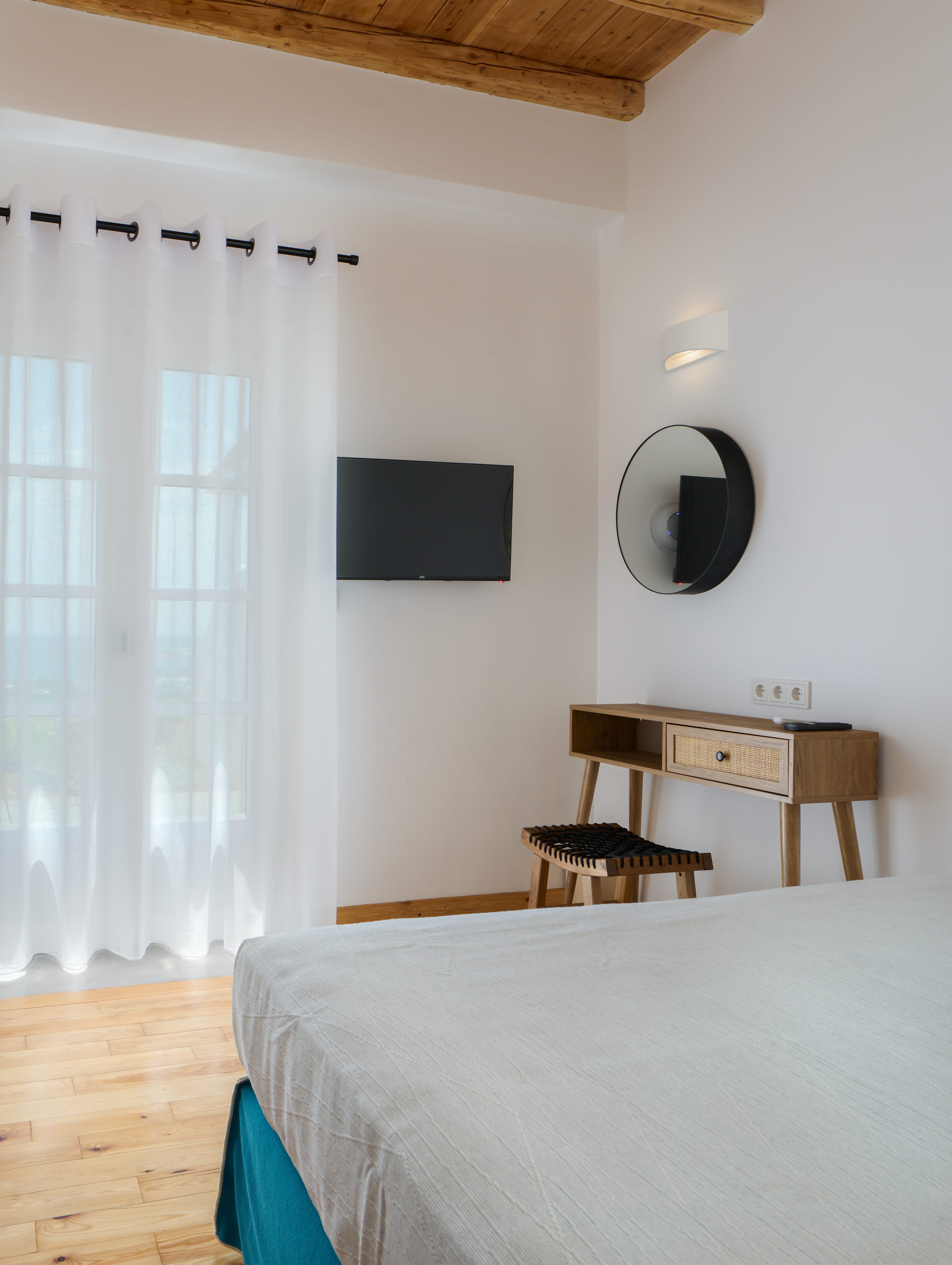 a bedroom with a bed and a mirror