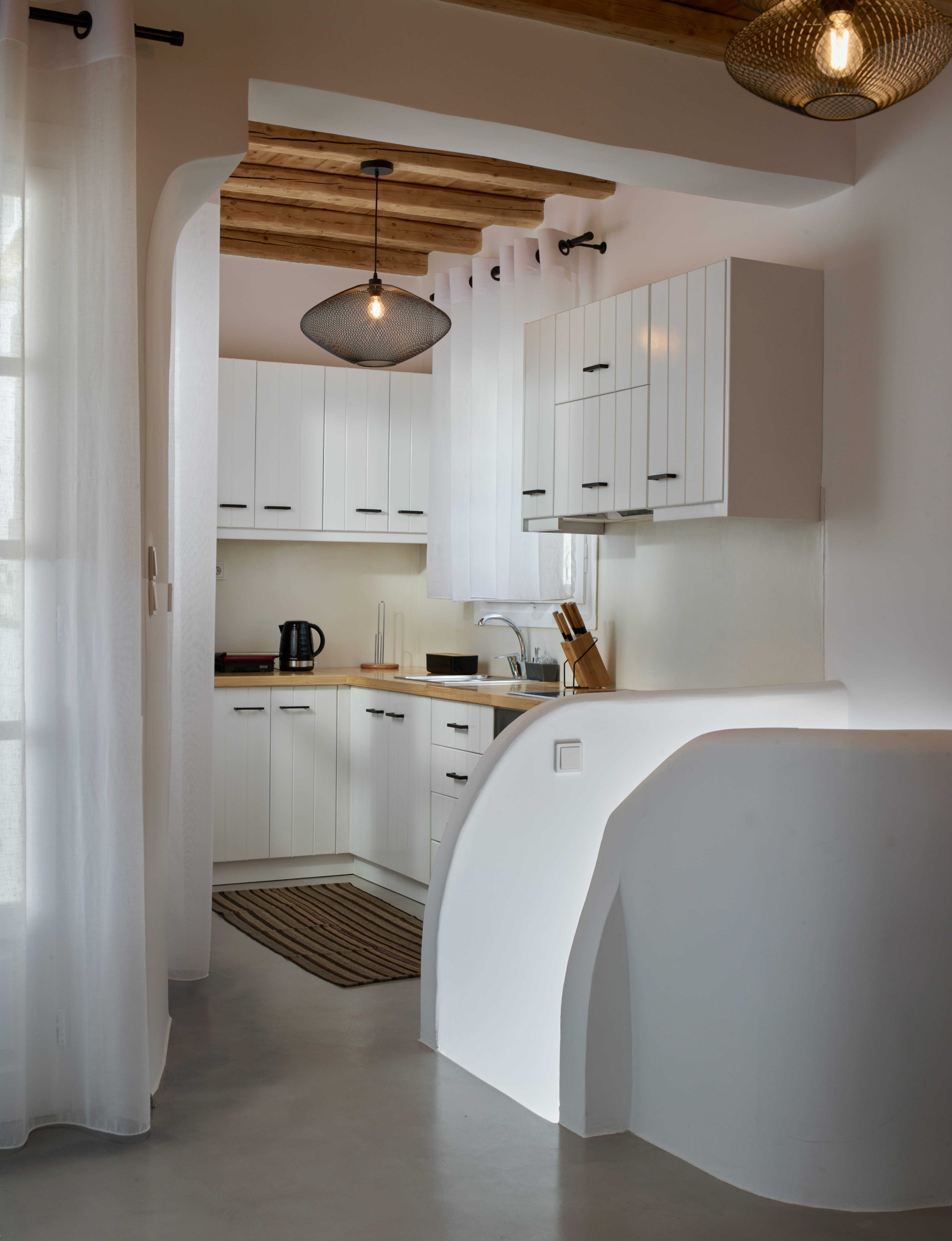 a kitchen with white cabinets