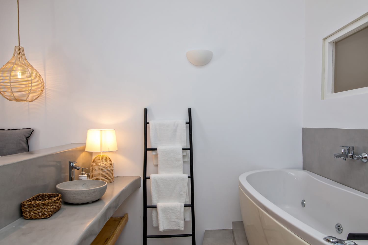 a bathroom with a tub sink and a mirror