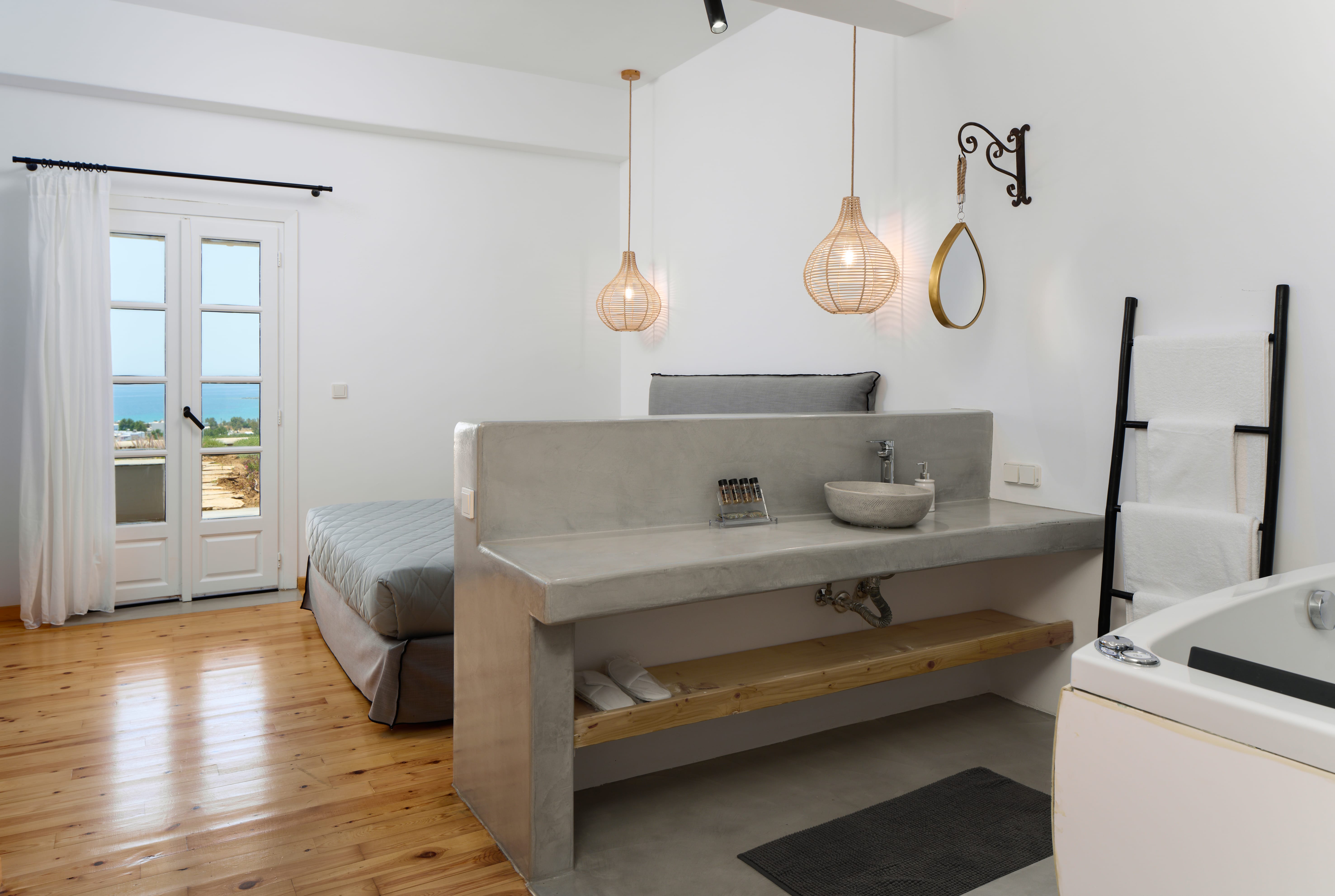 a bathroom with a tub sink and chandelier