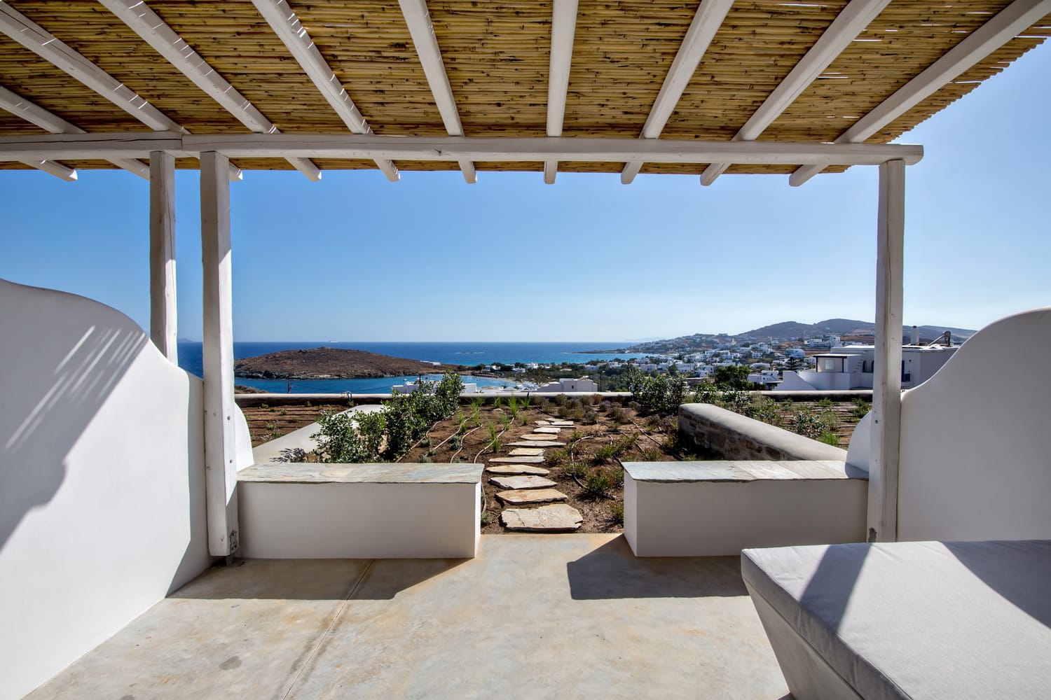 a roof with a view of the ocean and mountains