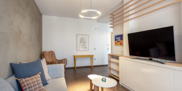 a living room with a tv and couches