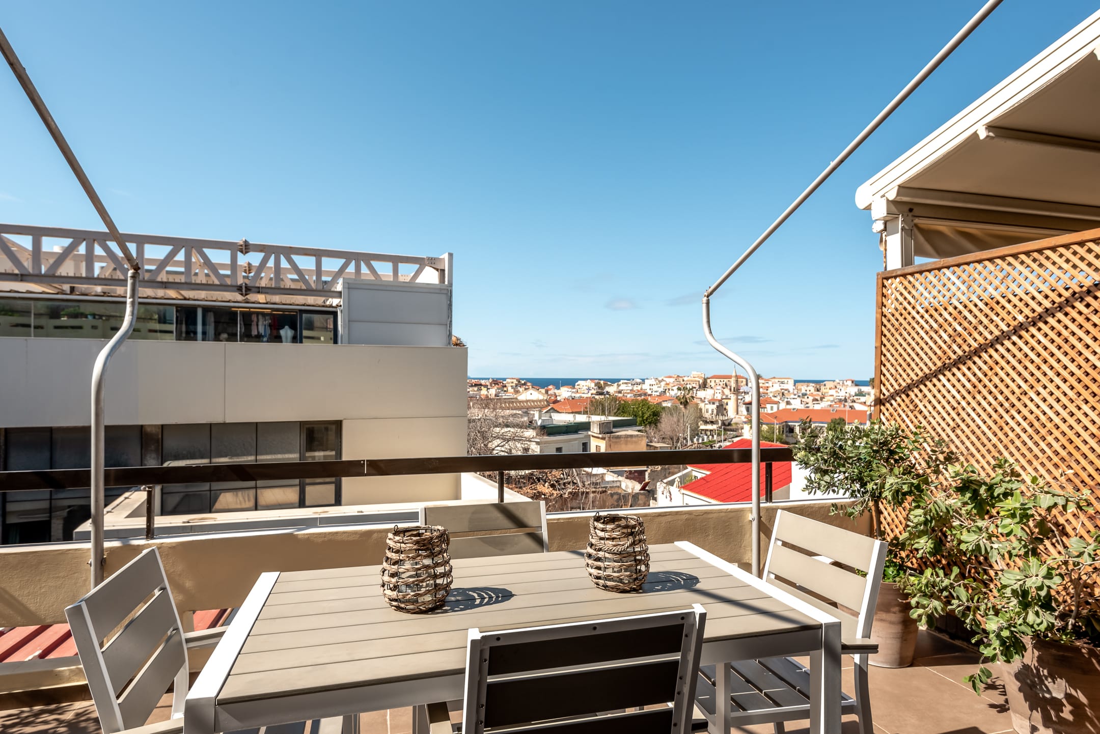 a rooftop with a table and chairs