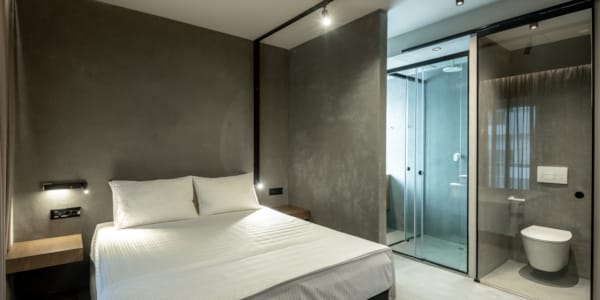 a bedroom with a large glass shower