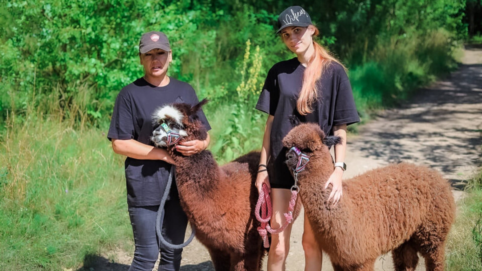 a couple of people holding animals