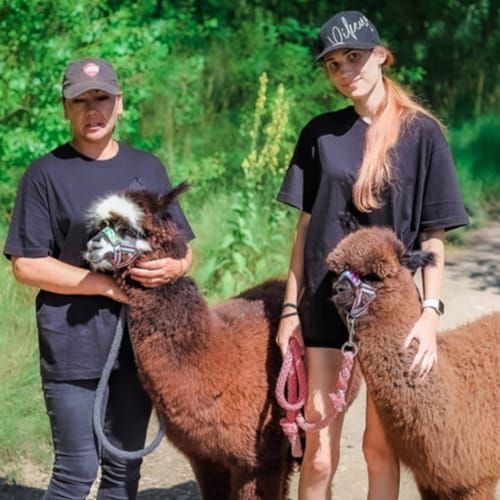a couple of people holding animals