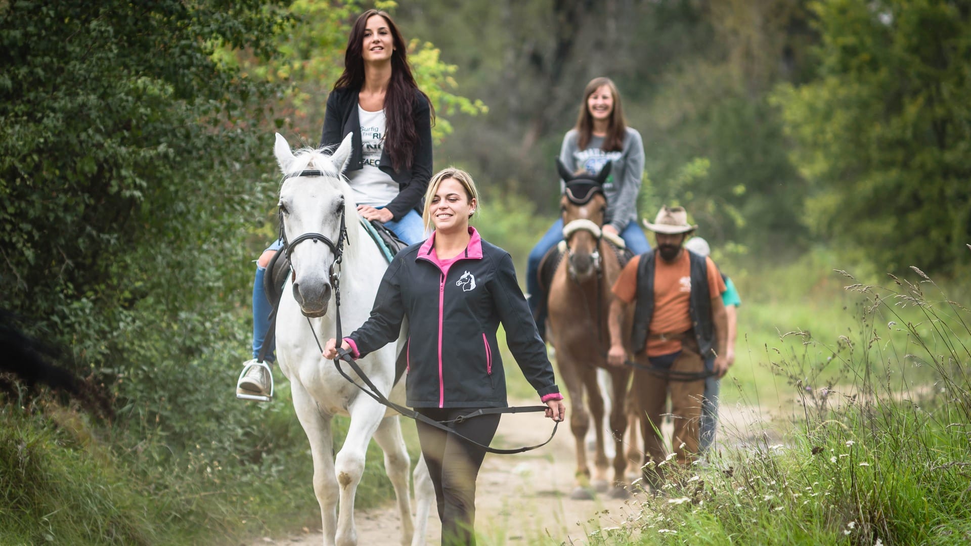 a group of people riding horses
