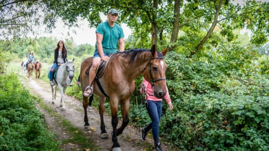 a group of people riding horses
