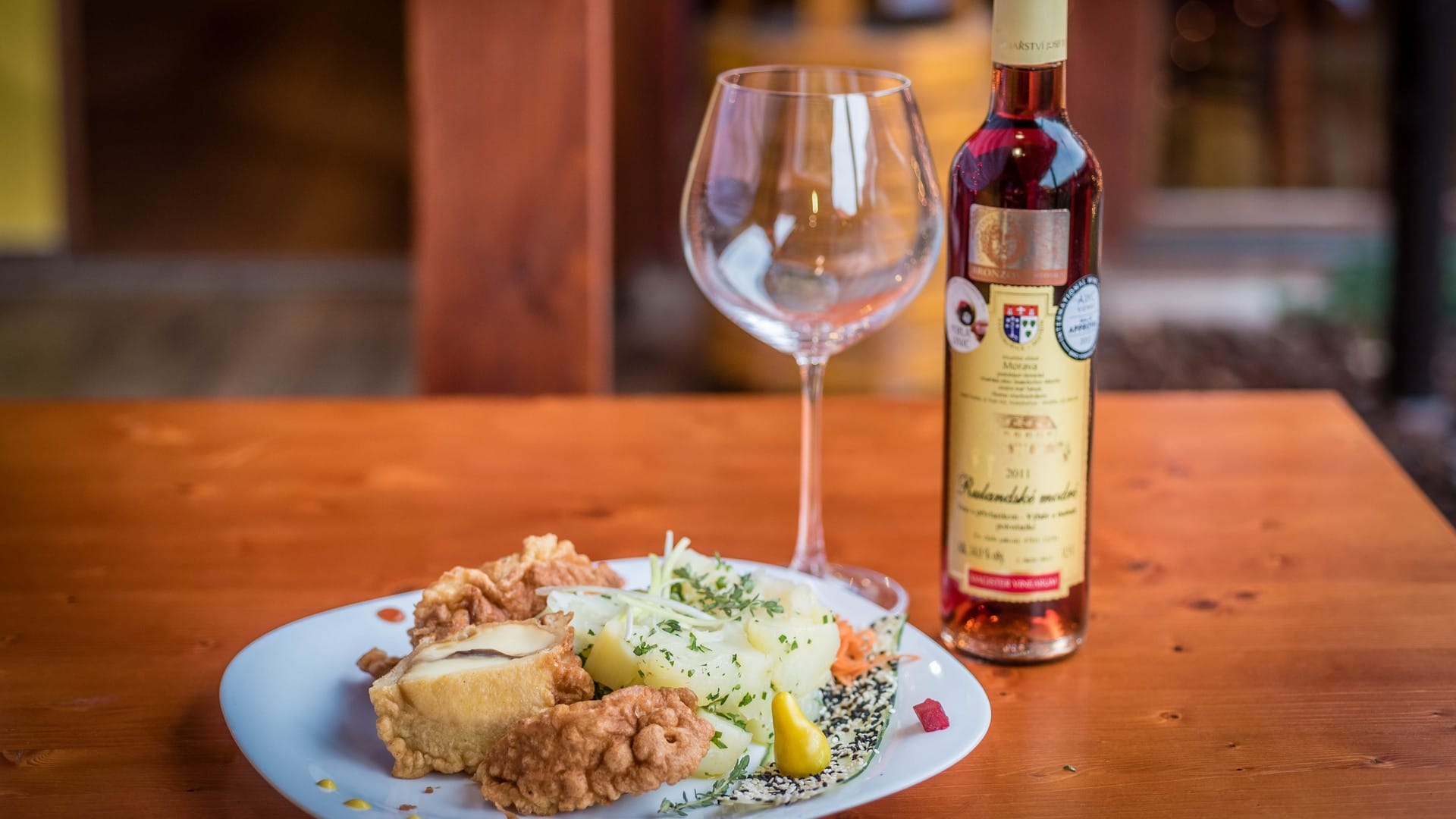 a plate of food and a bottle of wine on a table