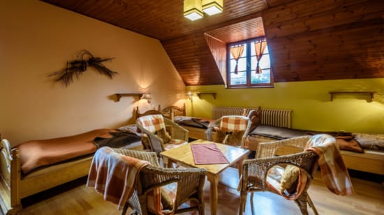 a room with a bed and chairs