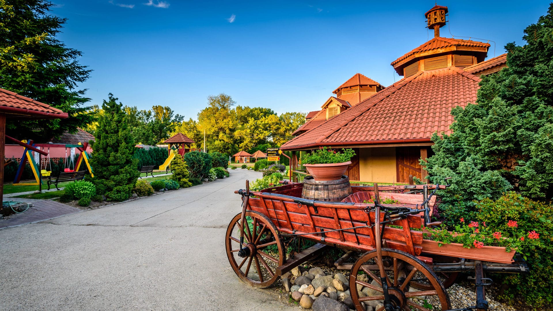 a wooden building with a red roof