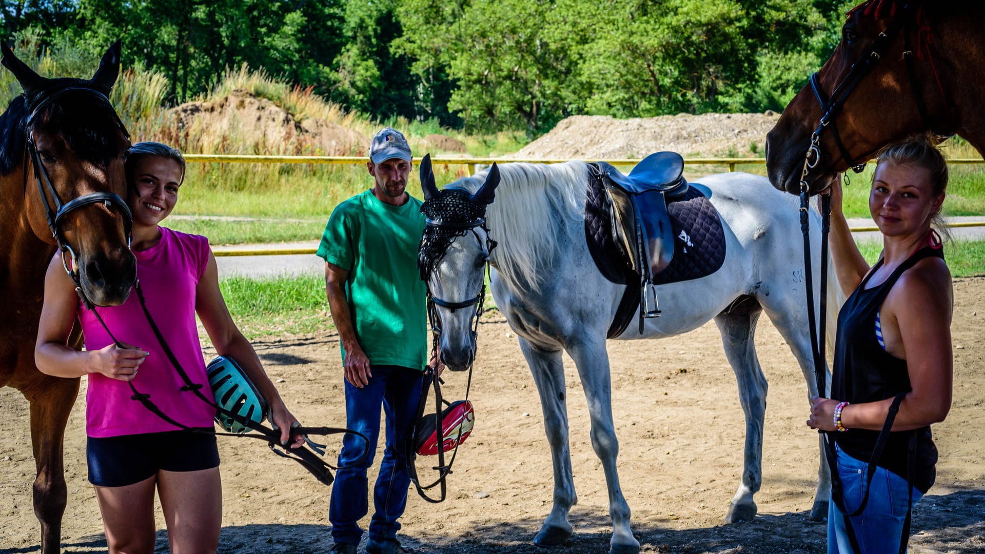 a group of people standing next to horses