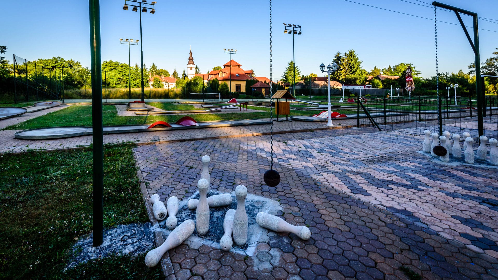 a brick road with a fountain